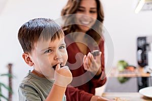 Mother and child making chocolate peanut cookies for quarantine