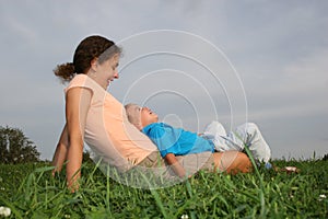 Mother with child on meadow