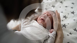 Mother and child. Mom calms, cradles a crying newborn baby. Mothers Day