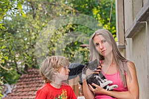 Mother and child, mom is holding a cat