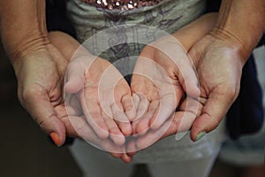 Mother and child with open hands together