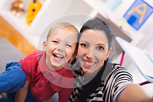 Mother with child photoshooting on smartphone selfie