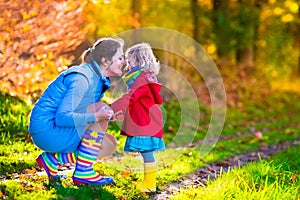 Mother and child playing in an autumn park