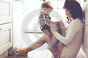 Mother and child playing with cat