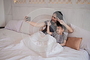 A mother and child are playing cell phones together