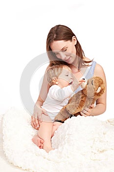 Mother and child playing with teddy