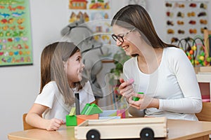 Mother and child Playing together with colorful didactic toys