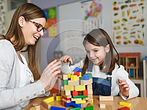 Mother and child Playing together with colorful didactic toys photo