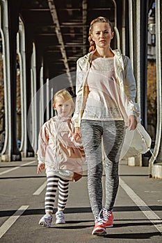 Mother and child on Pont de Bir-Hakeim bridge going forward