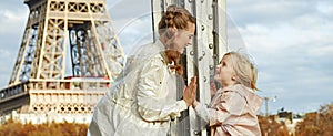 Mother and child on Pont de Bir-Hakeim bridge having fun time