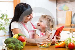 Mother and child preparing vegetables together at kitchen and lo