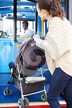 Mother With Child In Pushchair Boarding Bus