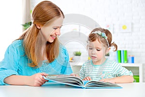 Mother and child reading book at home