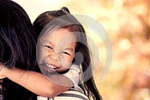 Mother and child resting on her mother`s shoulder