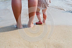 Mother and child`s foot on the beach photo