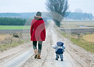 Mother and child on sandy road