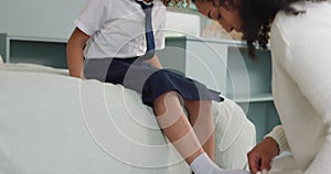 Mother, child and shoes in preparation for school, learning or education in the bedroom at home. Mom helping little girl