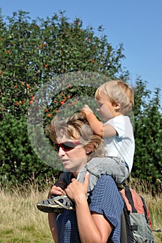 Mother with child on shoulders