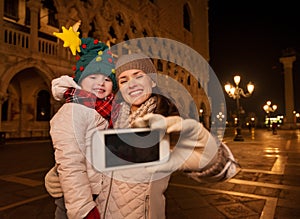 Mother and child taking selfie on Piazza San Marco in Venice