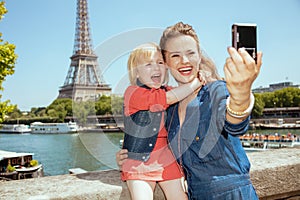 Mother and child tourists taking selfie with digital camera