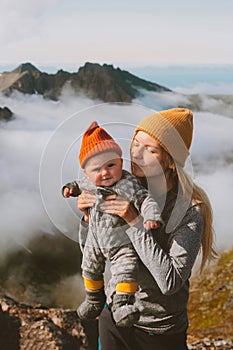 Mother with child travel in mountains family lifestyle woman hiking with infant baby