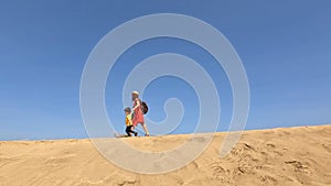 Mother and child on vacation in the dunes of Maspalomas, Gran Canaria