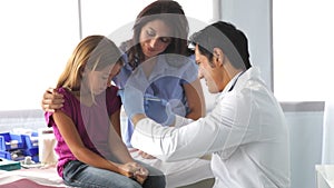 Mother And Child Visiting Doctor's Office