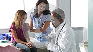 Mother And Child Visiting Doctor's Office