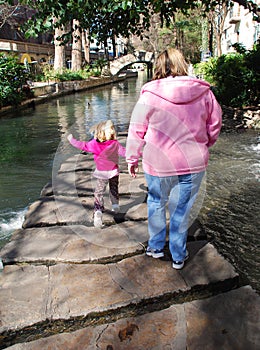Mother and child walk along the Riverwalk