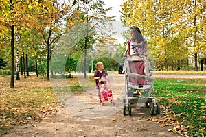 Mother with child walking across park