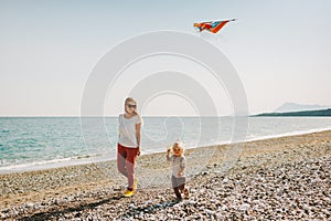 Mother and child walking on beach family travel vacations