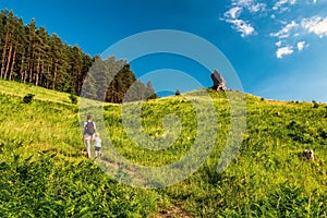 Mother with child walking on hiking trail