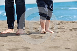Mother and child walking on a sandy beach