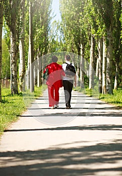 Mother and child walking together in summer city park