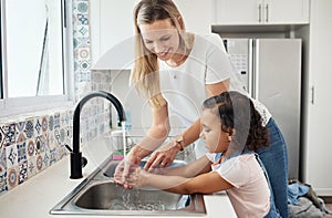 Mother, child and washing hands at kitchen sink at home for good hygiene, health and wellness. A woman and kid or