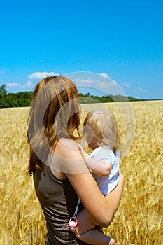 Mother with child at the wheat field