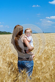 Mother with child at the wheat field