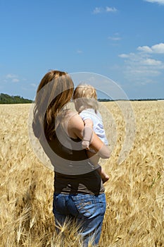 Mother with child at the wheat field