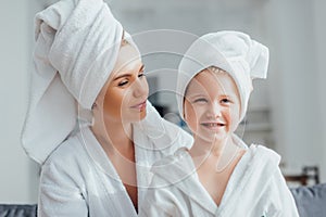 Mother and child in white bathrobes