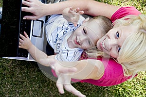 Mother and child working together on laptop