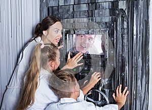 Mother with childred are helping dad and girl get out of the locked door