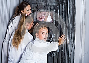 Mother with childred are helping dad and girl get out of the locked door