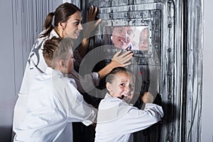 Mother with childred are helping dad and girl get out of the locked door