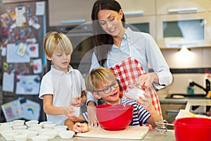 Mother and children baking together