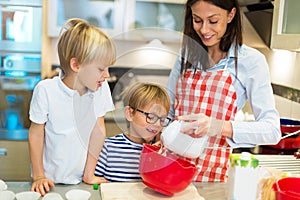 Mother and children baking together