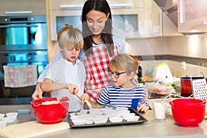 Mother and children baking together