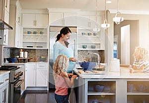 Mother, children and cookies in kitchen for baking with learning, bonding and preparation in home with sunlight. Family