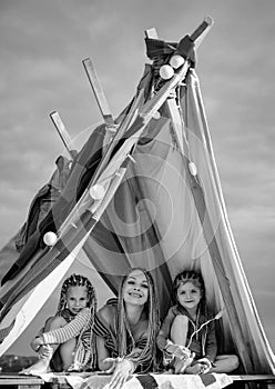 Mother with children daughter playing together in tent. Family camping. Mom with kids. Vacation concept. Mothers day