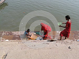 Mother and children doing laundry Assi Ghat Varanasi India