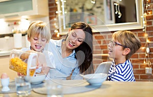 Mother with children eating breakfast